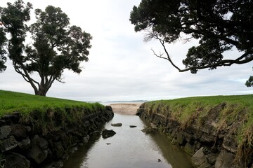 a small stream flows into the sea