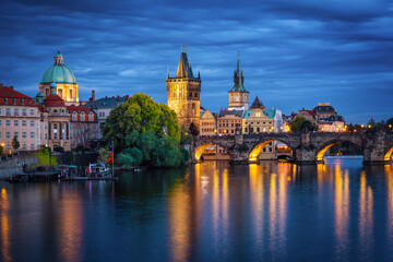 The illuminated cityscape of the old town of Prague with Charles Bridge and Vltava River during...