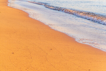 Soft wave of the sea on the sandy beach.