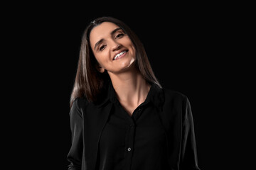 Beautiful young woman on black background