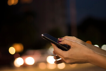 Close View of Female Hand Holding Smart Phone During Night