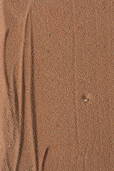 overhead view of chocolate brown sand, zen pattern drawn in the sand, Lines drawn in brown sand background, beautiful sand texture, Top view of fine grain texture
