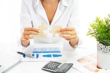 Business woman person hand holding puzzle piece idea for strategy and solution. Closeup part of two...