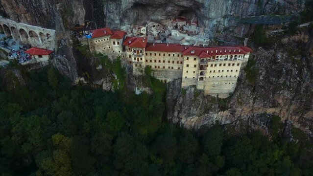 Aerial of the Sumala Monastery in Trabzon, Turkey surrounded by a big cliff and forests