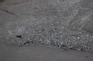 broken asphalt, a pothole in the road