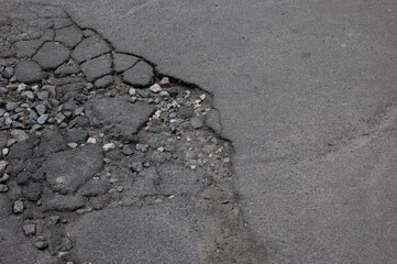 broken asphalt, a pothole in the road