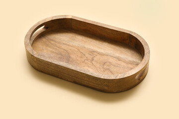 Empty wooden tray on beige background