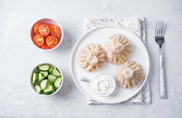 Khinkali with cream sauce in a plate