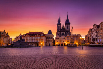 Fototapeta premium The old town square of Prague, Czech Republic, with the famous Tyn Church during a colorful summer sunrise, without people