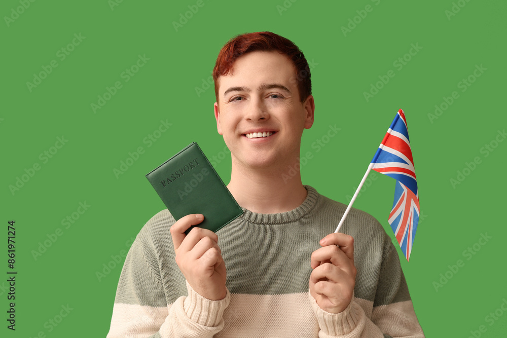 Poster handsome young happy man with uk flag and passport on green background