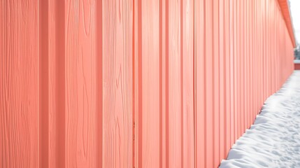 segment of vinyl siding in a light coral shade, with the crisp winter air highlighting its texture and frost resistance