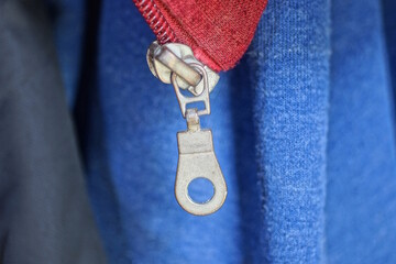 one gray metall open zip on  red blue cloth jacket