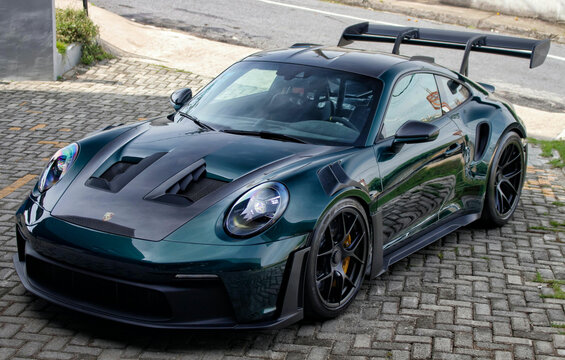 Green racecar on street, Porsche 911 GT3RS front view, Luxury super car