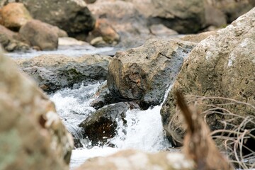 water flows over the rocks in a river in the mountains, the ohenemuri river