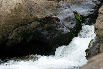 water flows over the rocks in a river in the mountains, the ohenemuri river