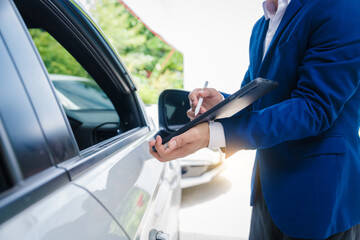 businessman in suit and car auto insurance agent assess car damage, discussing deductible, claims,...