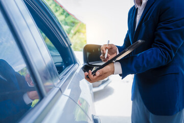 businessman in suit and car auto insurance agent assess car damage, discussing deductible, claims, coverage options comprehensive and collision insurance, completing necessary forms and appraisals.