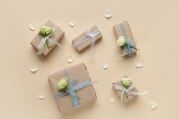 Gift boxes with beautiful white roses and petals on beige background. International Women's Day