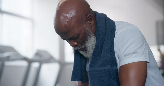 Black man, sweat and tired in gym with exercise for workout, training and health with self care. Break, burnout and exhausted with towel for routine or session on fitness, wellness and wellbeing