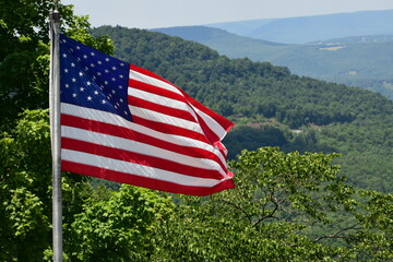  American flag in wind. Waving flag. American flag on pole. USA flag.