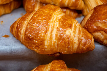 Breakfast in France, fresh baked butter croissants in artisanal bakery in Paris, France