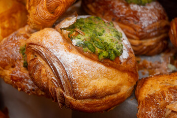 Fresh baked pastries for breakfast, pistachio croissant with cream filling
