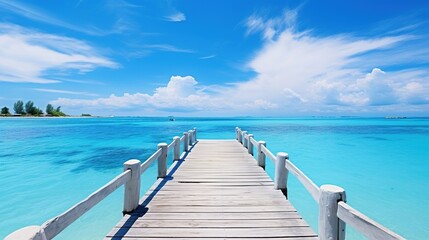 Fototapeta premium Wooden Pier Extending into a Clear Blue Ocean