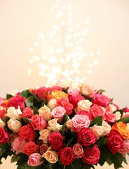 Beautiful bouquet of colorful roses on beige background