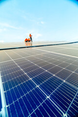 engineer man inspects construction of solar cell panel or photovoltaic cell by electronic device. Industrial Renewable energy of green power. factory worker working on tower roof.