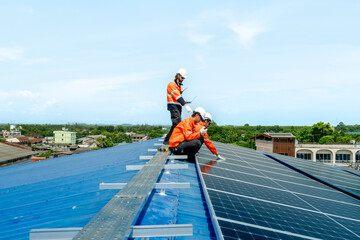 engineer man inspects construction of solar cell panel or photovoltaic cell by electronic device....