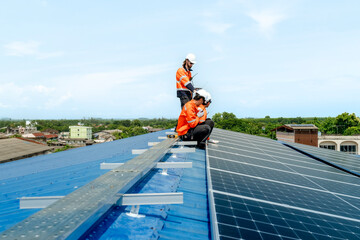 engineer man inspects construction of solar cell panel or photovoltaic cell by electronic device....