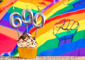 Birthday candle number 600 - Gay march flag background