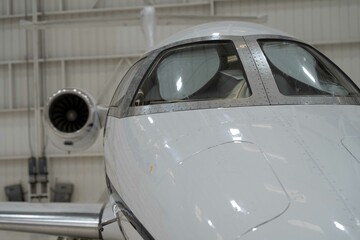 Close up of the windshield of a white private airplane.