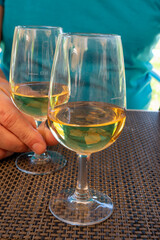 Tasting of Bordeaux white wine in Sauternes, left bank of Gironde Estuary, France. Glasses of white sweet French wine served in restaurant