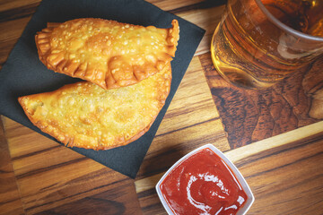 Homemade Brazilian Pastel with ketchup and a glass of Guarana. Typical Brazilian.