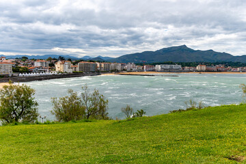 Fototapeta premium Saint-Jean-de-Luz fishing port on Basque coast, famous resorts, known for beautiful architecture, sandy beaches, cuisine, Santa Barba, South of France, Basque Country