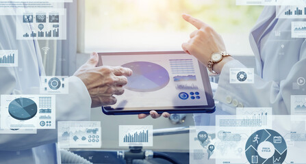 Researchers holding a meeting using a tablet and digital data concept.