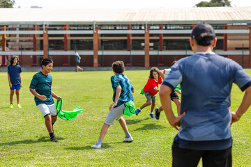 Obraz premium Youth Soccer Match with Colorful Training Bibs