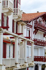 Houses and streets of old part of Saint-Jean-de-Luz fishing port on Basque coast, famous resort, known for beautiful architecture, sandy beaches, cuisine, South of France, Basque Country