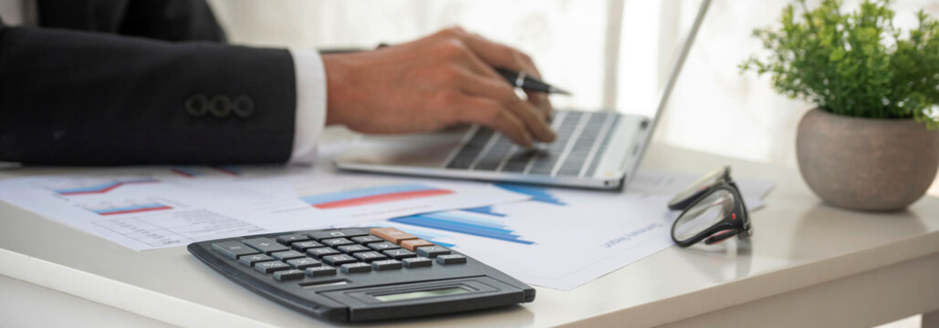 Banner Asian Business man hands using calculator counting tax financial bill. Tax audit Finacial concept. Panorama Close up businessman hands calculating number tax audit planning with copy space