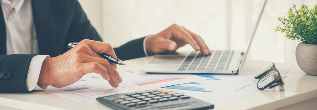 Banner Asian Business man hands using calculator counting tax financial bill. Tax audit Finacial concept. Panorama Close up businessman hands calculating number tax audit planning with copy space
