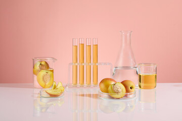 The creative photo on pink background of peach fruit and laboratory concept. Experiment tools...
