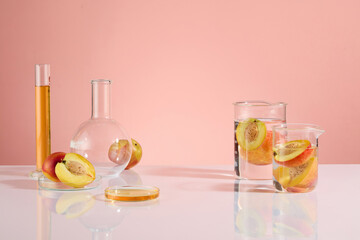 The photo of laboratory theme with peach ingredient, white table countertop displaying glassware of experiment. Vacant space for showing product and adding design elements, frontal shot