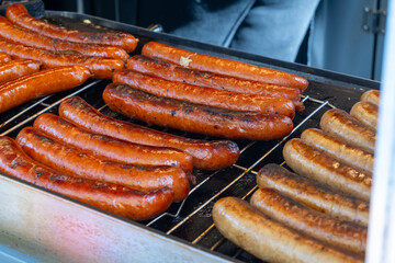 German street food on Portobello road Saturday food market, London, Uk, many BBQ grilled sausages ready to eat in outdoor café