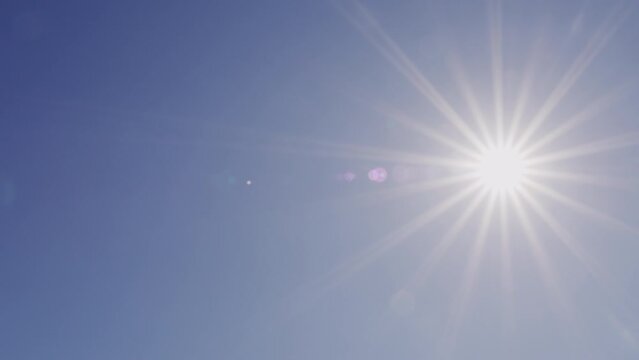 Bright Shining Sun In A Blue Sky No Clouds. Sunbeams And Flares Shining On Sunny Clear Blue Sky Background In Tropical Summer. Sunny Day.