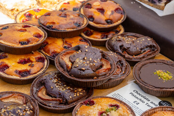 Sweet pastries, rustic apple cakes, cherry, almond cakes on food market in London, UK