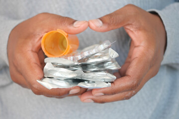  man holding empty pills of blister pack 