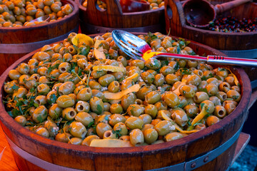 Pickled and marinated olives, artichokes, vegetables on farmers market, tasty tapas
