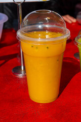 Colorful fresh pressed fruit yellow, orange juice with fresh fruits and berries