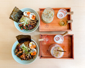 Delicious ramen bowls paired with refreshing iced drinks, the perfect combination for a satisfying meal
